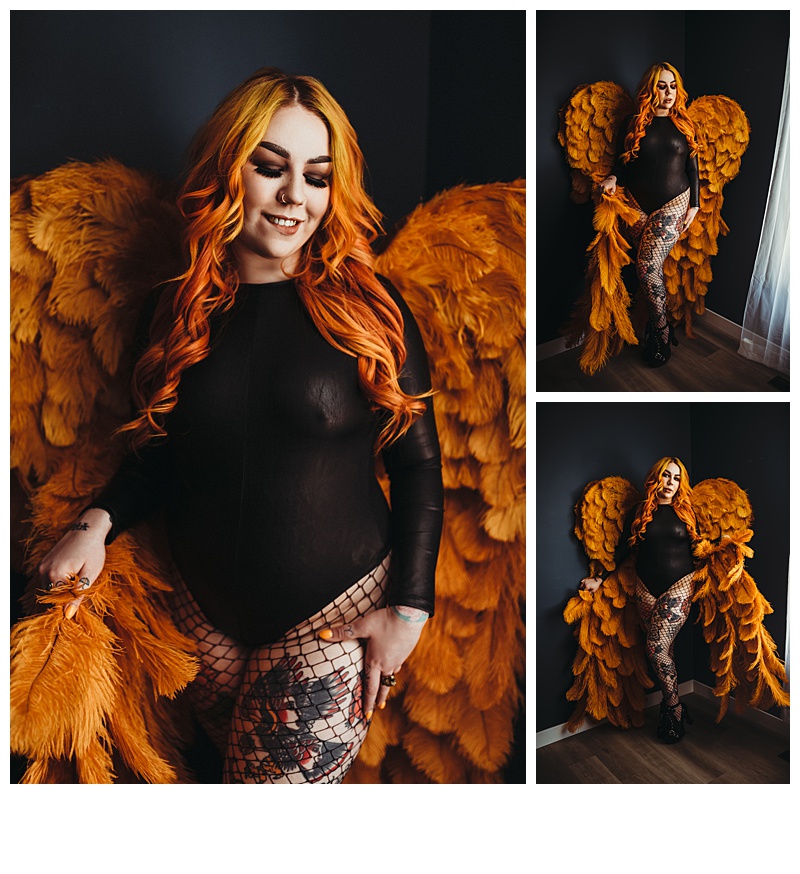woman with tattoos and orange hair and angel wings wearing a hush bodysuit and fishnets
